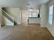 Open concept living room and kitchen, with carpeted living area and tiled kitchen area at 2305 Chatham Place Dr, Orlando, FL 32824