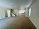 Large living room with open floor plan, carpet flooring, access to kitchen and staircase at 2305 Chatham Place Dr, Orlando, FL 32824