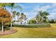 Community pool area with a clubhouse, surrounded by palm trees and well-maintained landscaping at 2305 Chatham Place Dr, Orlando, FL 32824