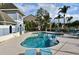Community pool surrounded by lounge chairs, palm trees, and manicured landscaping at 2305 Chatham Place Dr, Orlando, FL 32824