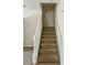 View of carpeted staircase leading to upper floor with white railing at 2305 Chatham Place Dr, Orlando, FL 32824