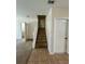 View of the carpeted staircase with white banister and multiple doors on the first floor at 2305 Chatham Place Dr, Orlando, FL 32824