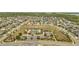 Expansive aerial view of the community featuring a pool, clubhouse, green space, and well-maintained homes in a suburban setting at 2348 Pearl Cider St, Orlando, FL 32824