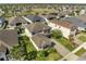 Aerial view of the well-manicured lawn and landscaping surrounding the home on a tree-lined street at 2348 Pearl Cider St, Orlando, FL 32824