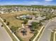 Aerial view showing a well-planned community with a playground, pool, and abundant green spaces for recreation and relaxation at 2348 Pearl Cider St, Orlando, FL 32824