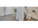 Hallway view of the front door and half bathroom with sink and toilet at 2348 Pearl Cider St, Orlando, FL 32824