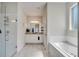 Bright bathroom featuring a walk-in shower, double vanity sinks, and a soaking tub at 2348 Pearl Cider St, Orlando, FL 32824