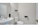 Half bathroom featuring a pedestal sink, toilet, and modern fixtures at 2348 Pearl Cider St, Orlando, FL 32824