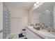 Bright bathroom with double vanity, ample counter space, and a blue patterned shower curtain at 2348 Pearl Cider St, Orlando, FL 32824