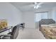 Inviting bedroom with natural light, carpeted floors, and a comfortable bed with work desk at 2348 Pearl Cider St, Orlando, FL 32824