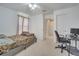 Comfortable bedroom with natural light, carpeted floors, and a comfortable bed with work desk at 2348 Pearl Cider St, Orlando, FL 32824