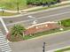 Elegant brick entrance sign welcomes you to Woodland Park, enhanced by colorful landscaping at 2348 Pearl Cider St, Orlando, FL 32824