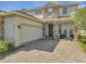 Charming two-story home featuring stone accents, a spacious garage, and a beautifully paved driveway at 2348 Pearl Cider St, Orlando, FL 32824