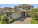 Charming two-story home featuring stone accents, a spacious garage, and a beautifully paved driveway at 2348 Pearl Cider St, Orlando, FL 32824