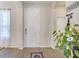 Bright foyer with wood-look tile flooring, white front door, and decor at 2348 Pearl Cider St, Orlando, FL 32824