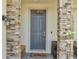 Close-up of a front porch featuring stone pillars and a cozy seating area near the front door at 2348 Pearl Cider St, Orlando, FL 32824