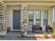 Inviting front porch with stone pillars, comfortable seating, and a welcoming entrance at 2348 Pearl Cider St, Orlando, FL 32824