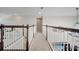 Upstairs hallway with carpet flooring, white railings, and a clear view of the upper level at 2348 Pearl Cider St, Orlando, FL 32824