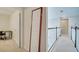 Bright hallway with carpet, white walls, and wooden railing accents enhance the upstairs landing at 2348 Pearl Cider St, Orlando, FL 32824