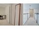 Bright hallway with carpet, white walls, and wooden railing accents enhance the upstairs landing at 2348 Pearl Cider St, Orlando, FL 32824