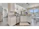 Bright kitchen features white cabinets, modern lighting fixtures and stainless steel dishwasher at 2348 Pearl Cider St, Orlando, FL 32824