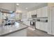 Bright kitchen featuring granite countertops, stainless steel appliances, and white cabinets at 2348 Pearl Cider St, Orlando, FL 32824