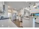 Bright kitchen with white cabinets, stainless steel appliances, and a large island with counter seating at 2348 Pearl Cider St, Orlando, FL 32824