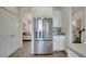 Stainless steel refrigerator complements the white cabinets and gray countertops in the kitchen at 2348 Pearl Cider St, Orlando, FL 32824