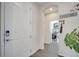 Hallway view of the front door and laundry room featuring a washer and dryer at 2348 Pearl Cider St, Orlando, FL 32824