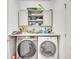 Laundry area with modern washer and dryer, countertops, and upper cabinets at 2348 Pearl Cider St, Orlando, FL 32824