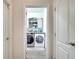 Laundry room with modern washer and dryer with storage at 2348 Pearl Cider St, Orlando, FL 32824