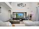 Living room with dark wood entertainment center and views of the upstairs balcony at 2348 Pearl Cider St, Orlando, FL 32824