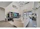 Bright living room with a modern chandelier, high ceilings, and an entertainment center with large TV at 2348 Pearl Cider St, Orlando, FL 32824