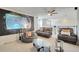 Bright upstairs living room area with ceiling fan, couches, and a unique tapestry at 2348 Pearl Cider St, Orlando, FL 32824
