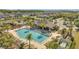 Aerial view of a community pool with ample lounge chairs, palm trees, and a covered pavilion, inviting relaxation and recreation at 2348 Pearl Cider St, Orlando, FL 32824