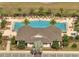 Overhead view of the community pool and clubhouse surrounded by lounge chairs, manicured lawns, and lush landscaping at 2348 Pearl Cider St, Orlando, FL 32824