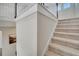 Carpeted stairway with white banister, wood handrail and neutral paint at 2348 Pearl Cider St, Orlando, FL 32824