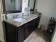 Bathroom with double vanity, granite countertops, and modern fixtures at 2522 Nouveau Way, Kissimmee, FL 34741