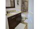 Bathroom featuring a granite-topped vanity, tiled shower, and modern fixtures at 2522 Nouveau Way, Kissimmee, FL 34741