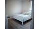 Bright bedroom features wood floors, white walls, and a white bed at 2522 Nouveau Way, Kissimmee, FL 34741