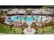 Stunning aerial view of the community pool with palm trees and plenty of seating at 2522 Nouveau Way, Kissimmee, FL 34741