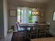 Bright dining room area features a modern chandelier, laminate flooring, and sliding glass doors to the backyard at 2522 Nouveau Way, Kissimmee, FL 34741