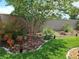 Beautiful landscaping featuring lush green grass and colorful plants at 2522 Nouveau Way, Kissimmee, FL 34741