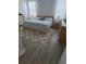 Cozy main bedroom with a neutral color palette, wood flooring, and a patterned rug for added comfort at 2522 Nouveau Way, Kissimmee, FL 34741