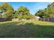 Spacious backyard featuring a large grassy area, wood fence, and mature trees for plenty of shade at 2535 Georgia Ave, Sanford, FL 32773
