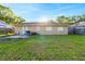 Spacious backyard with a grassy lawn, small patio, and lots of natural light at 2535 Georgia Ave, Sanford, FL 32773