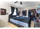 Cozy bedroom with ceiling fan and a closet with clothes, offering comfort and storage at 2535 Georgia Ave, Sanford, FL 32773