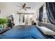 A comfortable bedroom featuring a ceiling fan, natural light, and a sliding barn door at 2535 Georgia Ave, Sanford, FL 32773