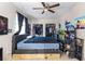 Cozy bedroom with ceiling fan and a closet with clothes, offering comfort and storage at 2535 Georgia Ave, Sanford, FL 32773