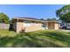 Well-maintained exterior view of a single-story home featuring a manicured lawn and mature trees at 2535 Georgia Ave, Sanford, FL 32773
